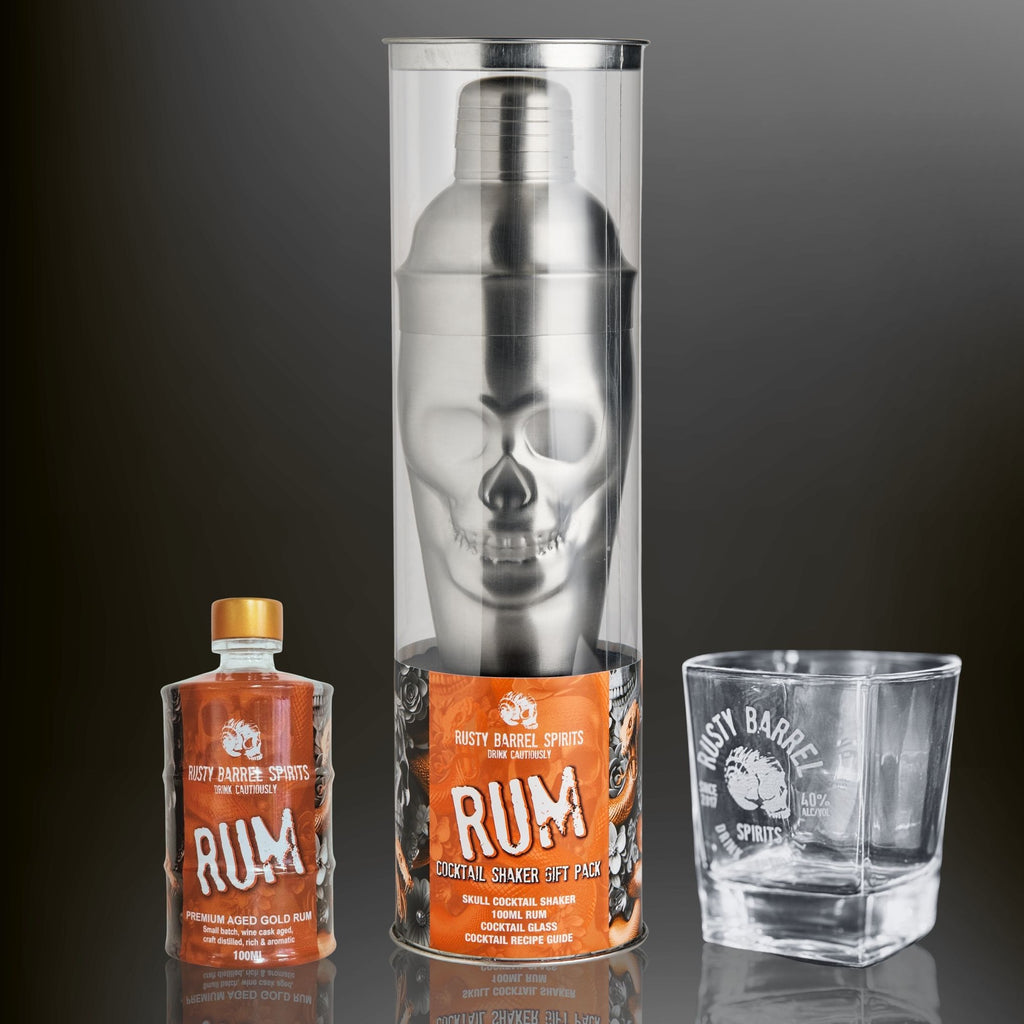 Rusty Barrel Spirits Skull Cocktail shaker set with rum bottle and glass on a dark background