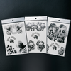 Three temporary tattoos with black and white designs, including skulls and flowers, displayed on paper transfers.