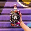 Bottle of Rusty Barrel Vodka 700ml held by a hand against a colorful graffiti background