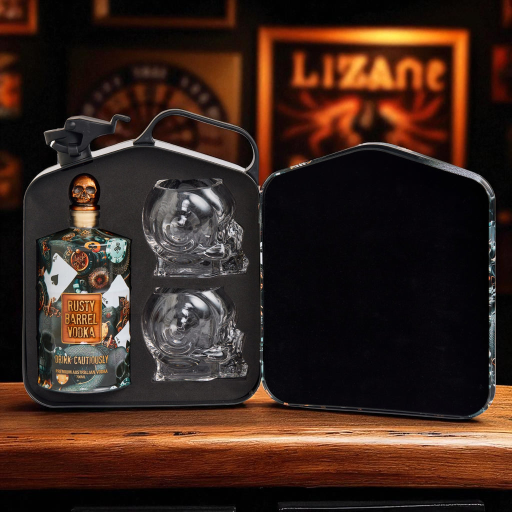 Rusty Barrel Vodka bottle with skull-shaped glasses in a black metal case on a wooden surface.