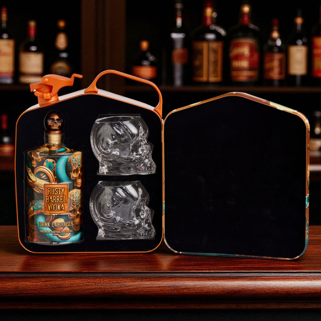 Rusty Barrel Vodka bottle and skull-shaped glass in a carrying case with a dark background.