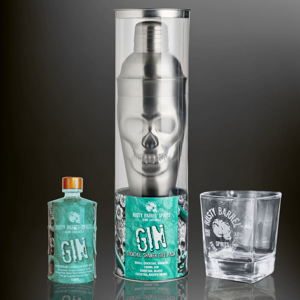 Rusty Barrel Spirits Cocktail shaker with skull design, gin bottle, and glass on a dark background