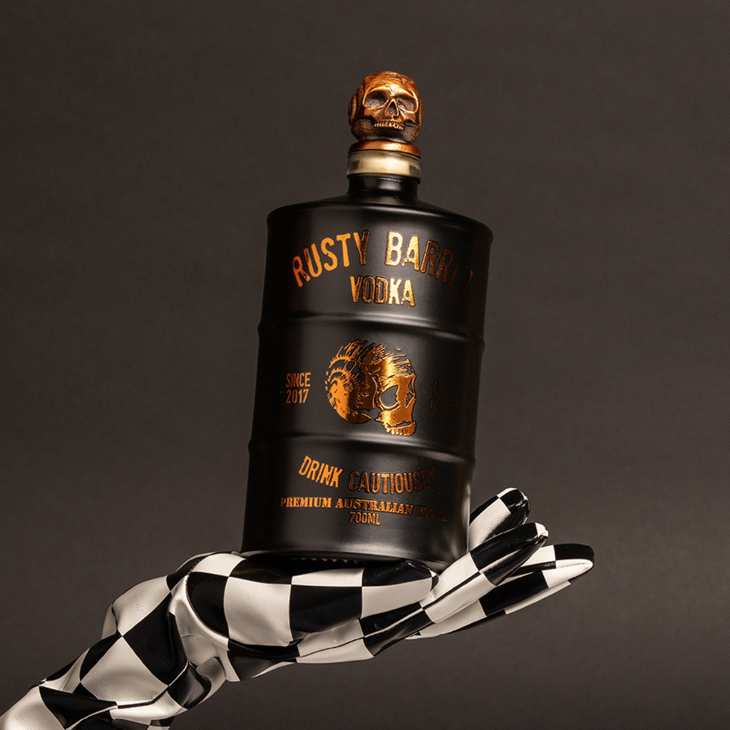 Bottle of Rusty Barrel Vodka 700ml Matte Black with a skull design against a dark background
