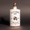 Bottle of Rusty Barrel Vodka 700ml Matte White with skull design on a dark background