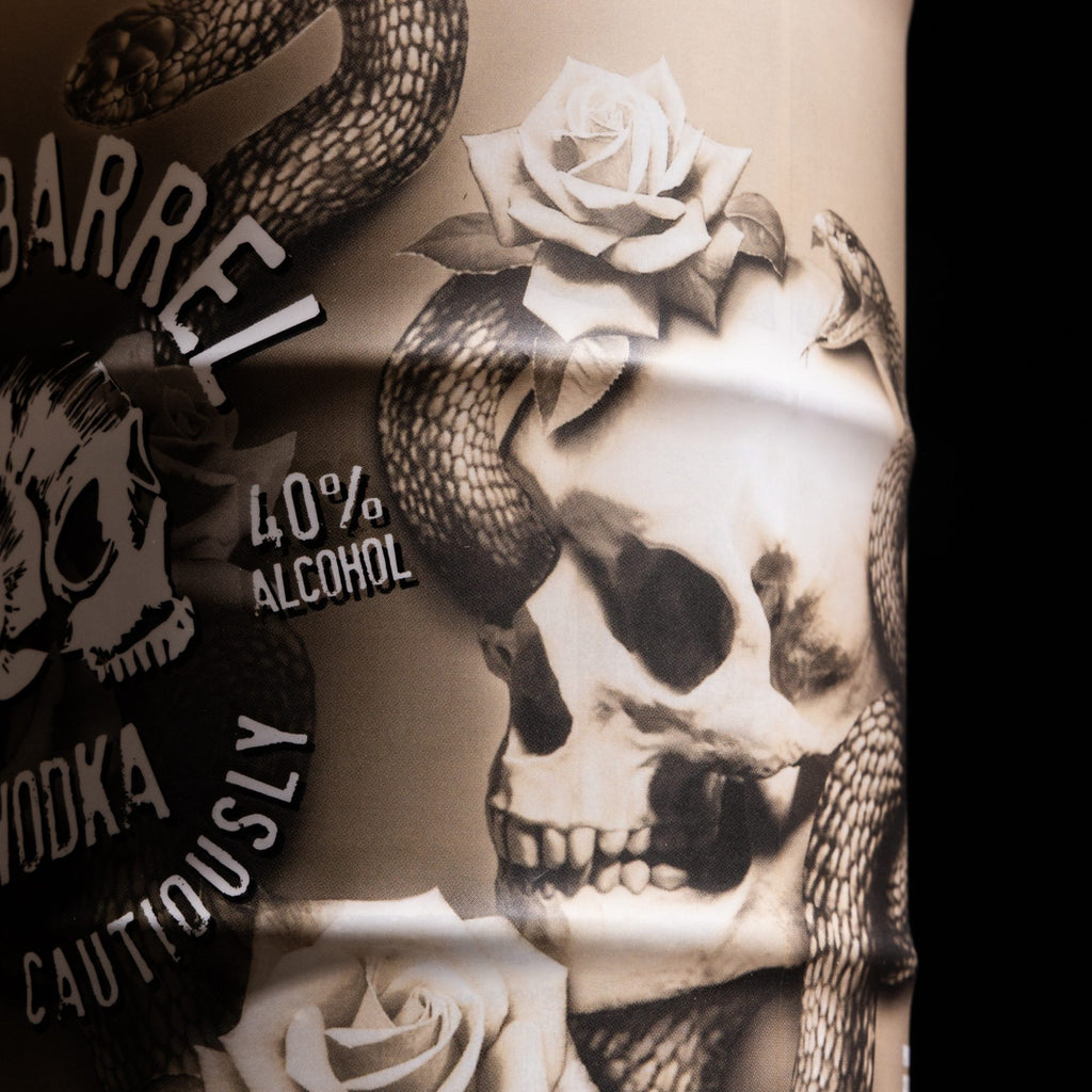 Rusty Barrel Vodka 700ml Bondi Ink Tattoo design of a skull with roses and a snake on a bottle label in the background
