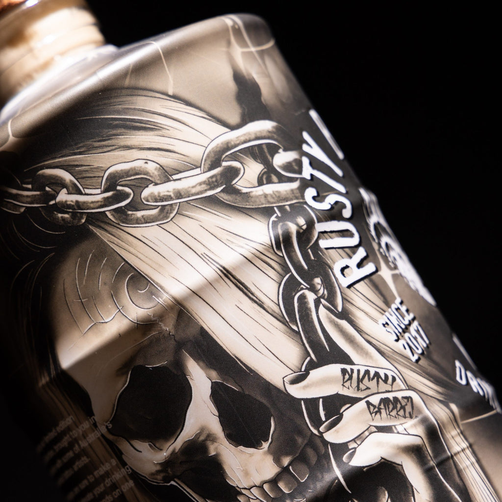 Close-up of a Rusty Barrel Vodka 700ml Deadmind bottle with a skull and chain design, featuring the brand 'Rusty Barrel'.