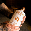 Bottle of Rusty Barrel Vodka 700ml Matte White with skull design on a dark background